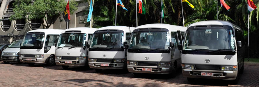 Mayelane Tours vehicle fleet including luxury 22-seater and 13-seater buses in Victoria Falls, Zimbabwe, ready for group transfers and regional travel